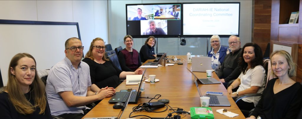 Picture of people around a large table in a boardroom